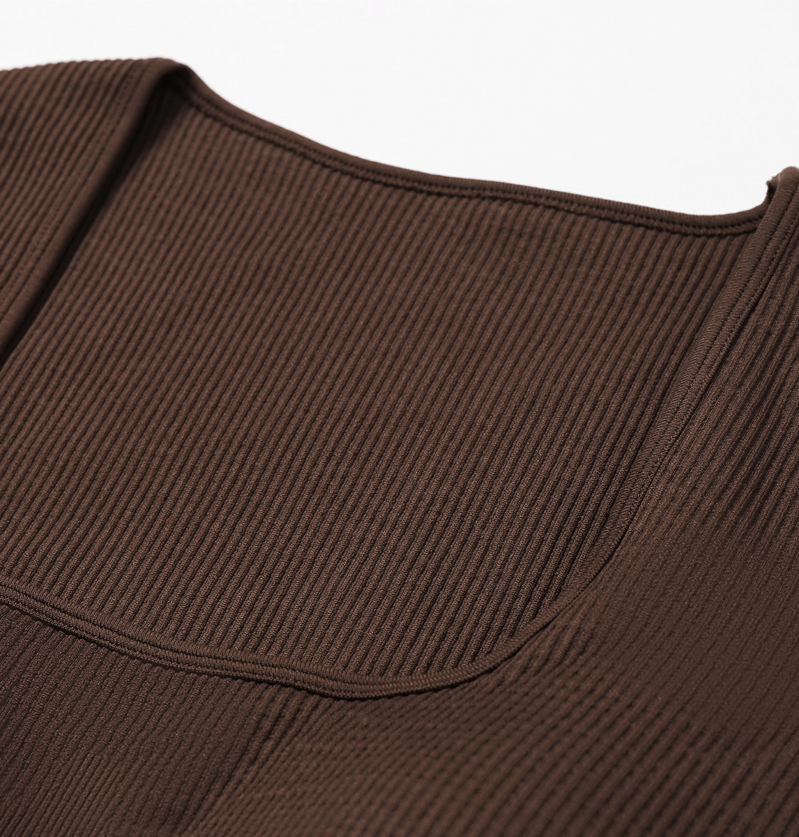Close-up of brown seamless yoga suit fabric showcasing ribbed texture for enhanced breathability and style.